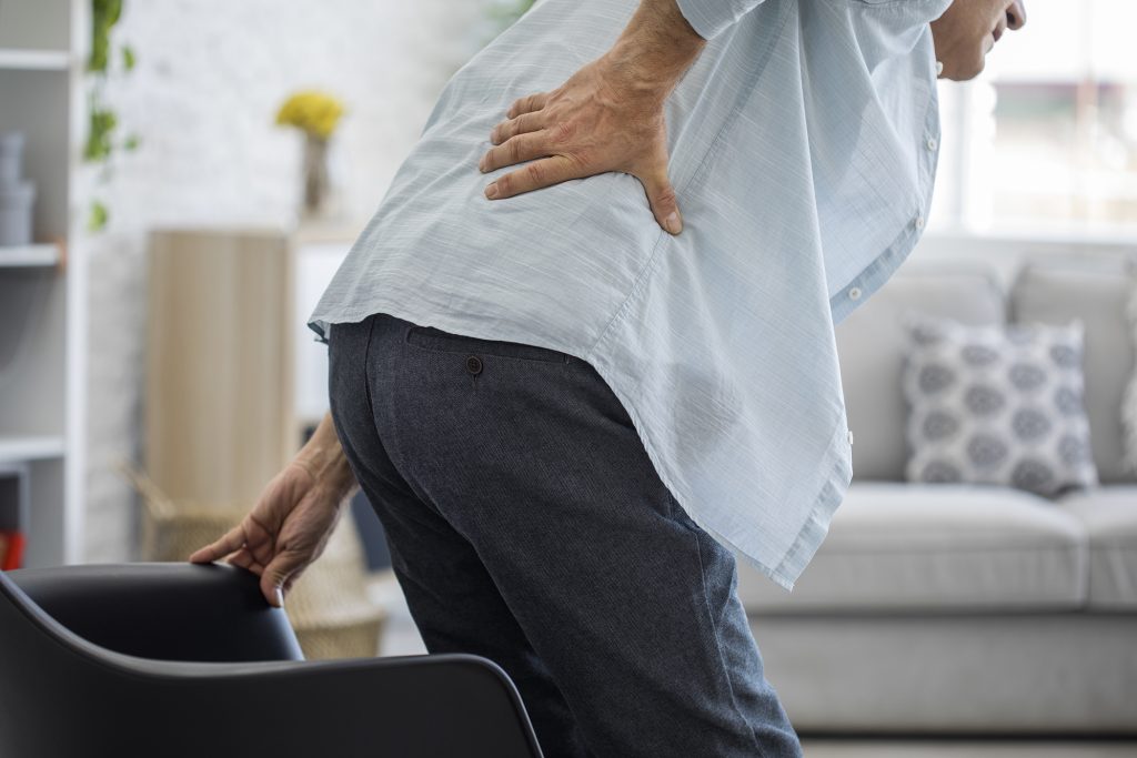 woman leaning over with back pain